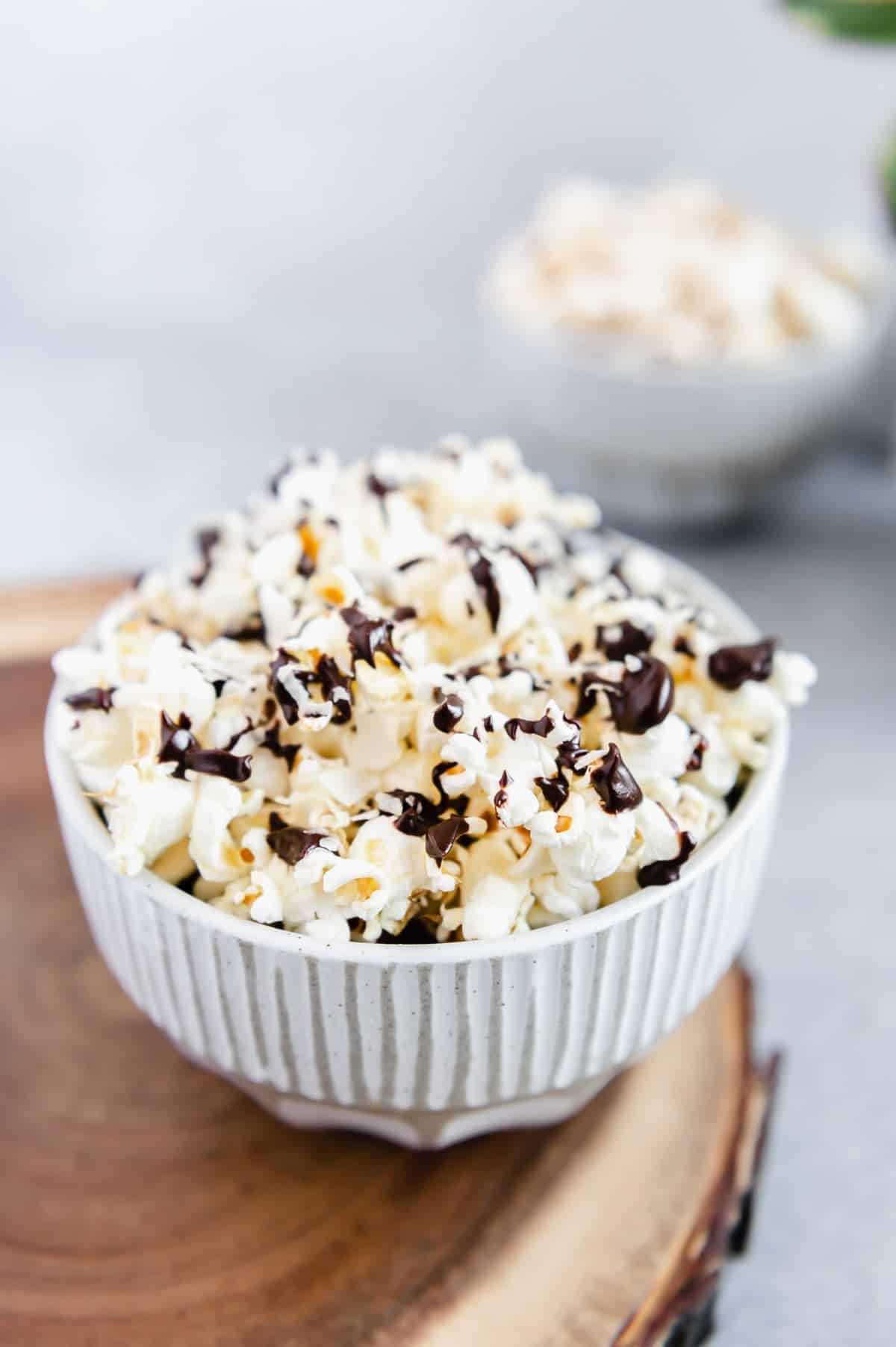 Upclose photo of a bowl of chocolate coconut popcorn.