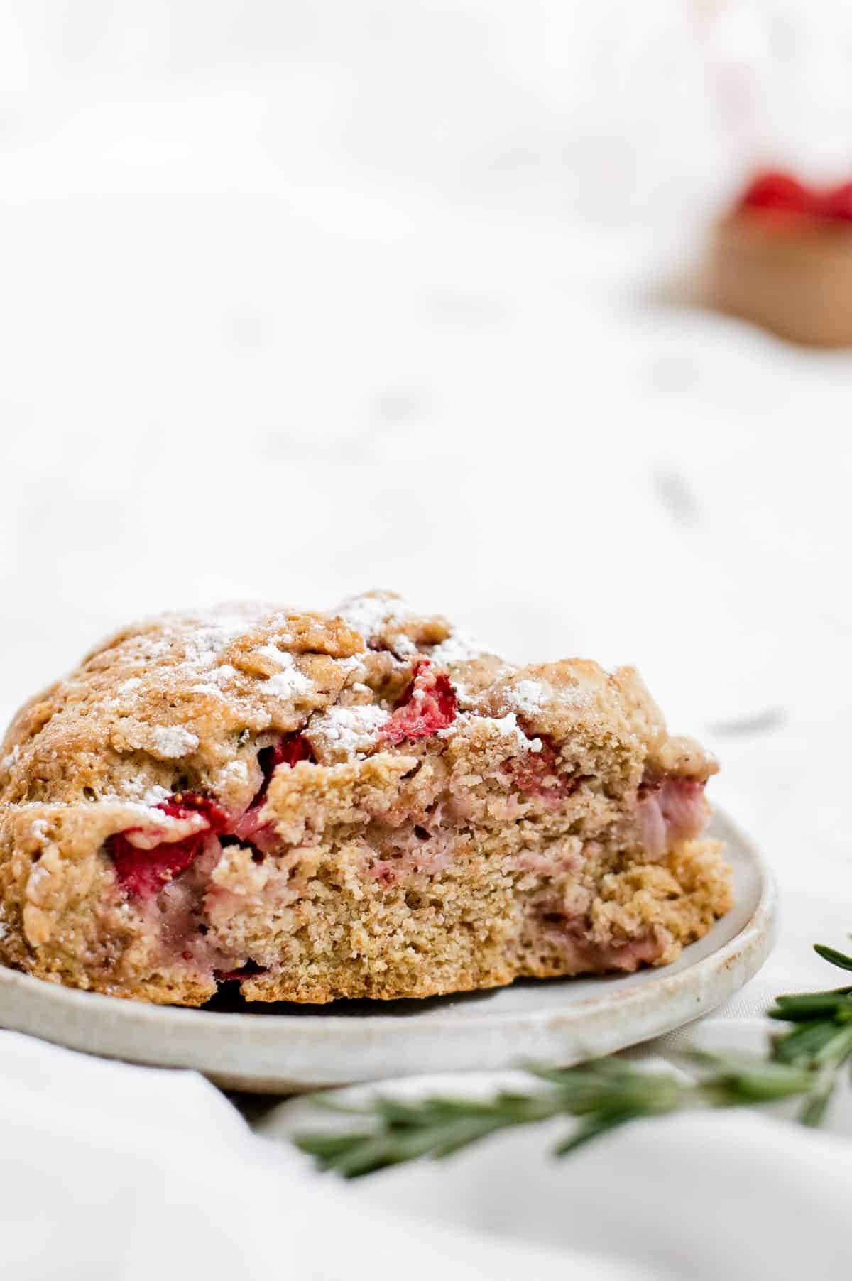 Close-up side view of vegan strawberry rosemary scones.