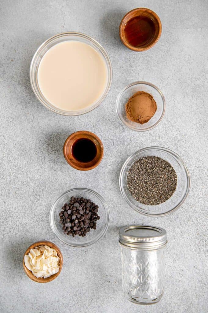 Overhead of ingredients for an overnight chocolate chia pudding in bowls.