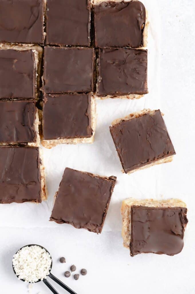 Overhead of squares of vegan millionaire shortbread cookies.