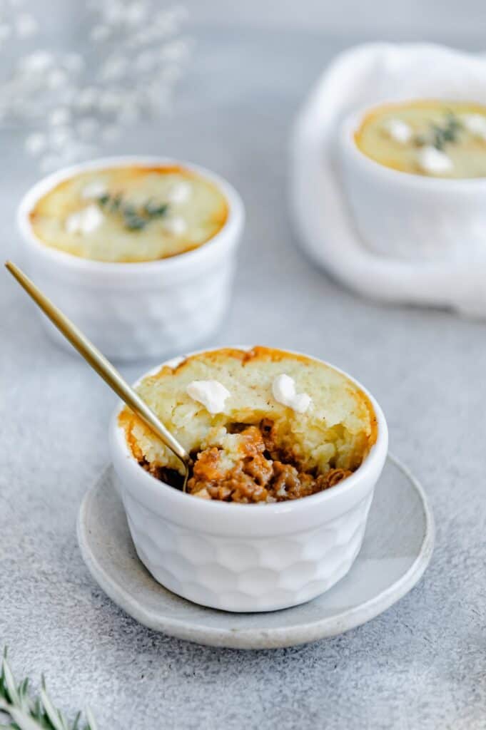 Half eaten shepherd's pie with a spoon sticking out of it.