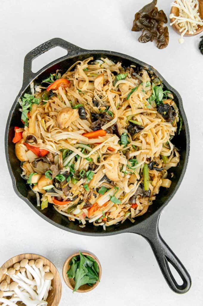Overhead of a cast iron skillet with Asian stir fry.