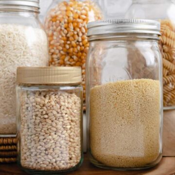 Up close of barley and couscous in mason jars.