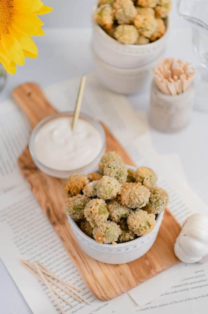 The perfect party appetizer - fried olives - on a wood serving board.