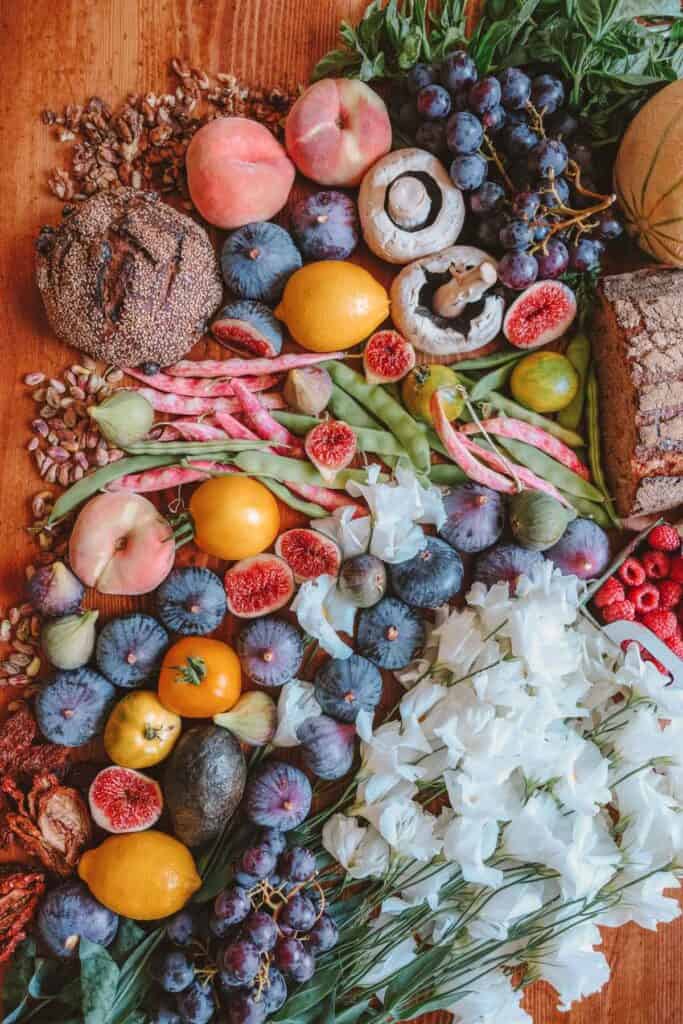 Flat lay of various fruits, vegetables, and whole grains.