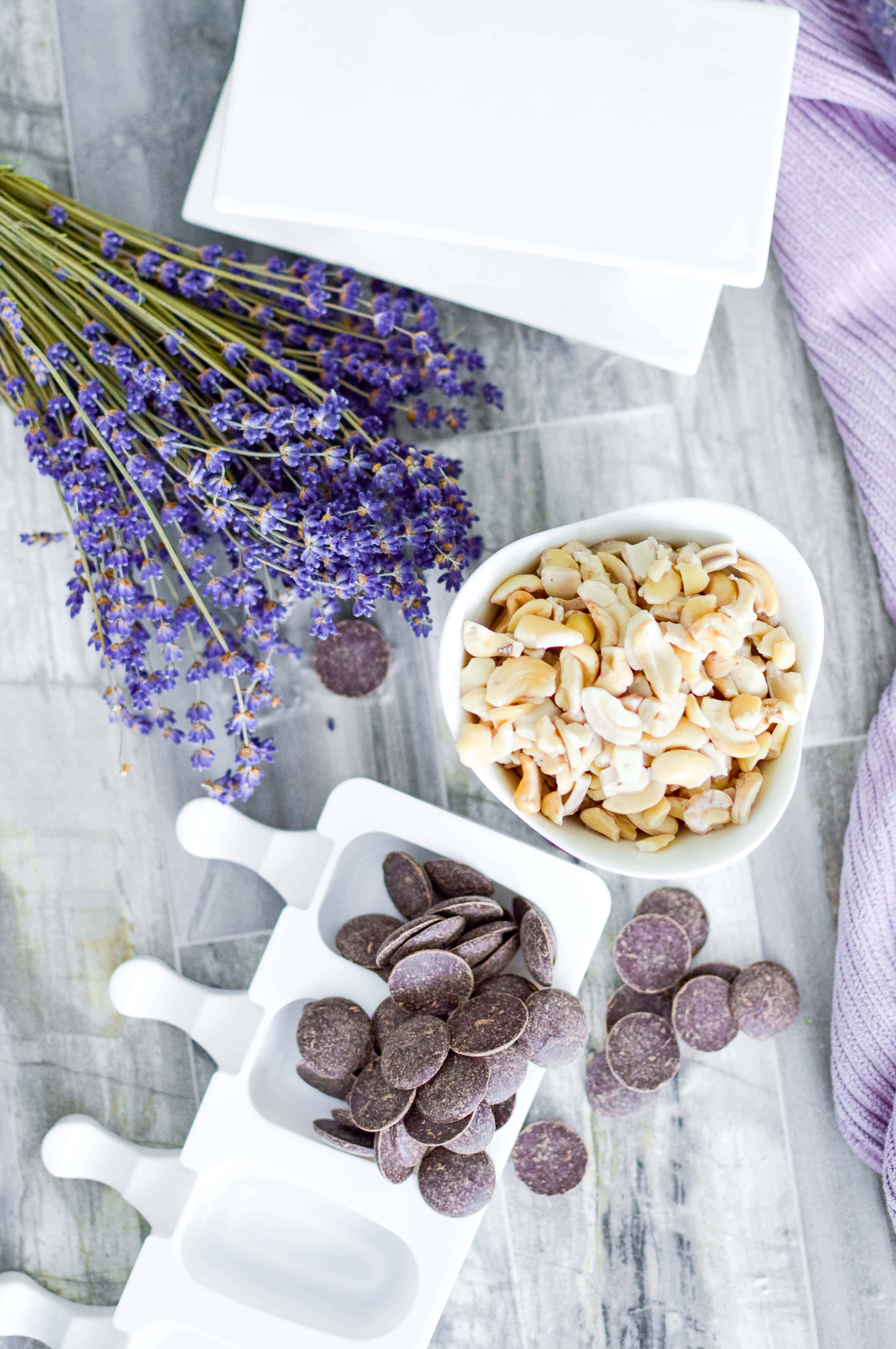 Flat lay of ingredients for making ice cream bars - lavender, cashews, and chocolate wafers.
