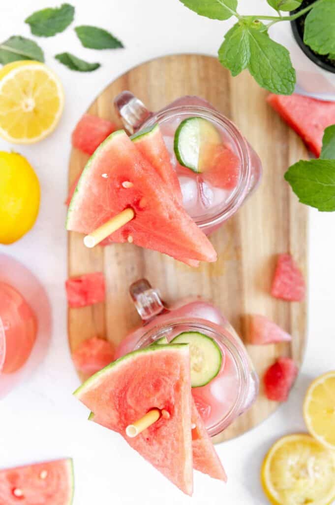 Overhead of watermelon cucumber lemonade with paper straws.