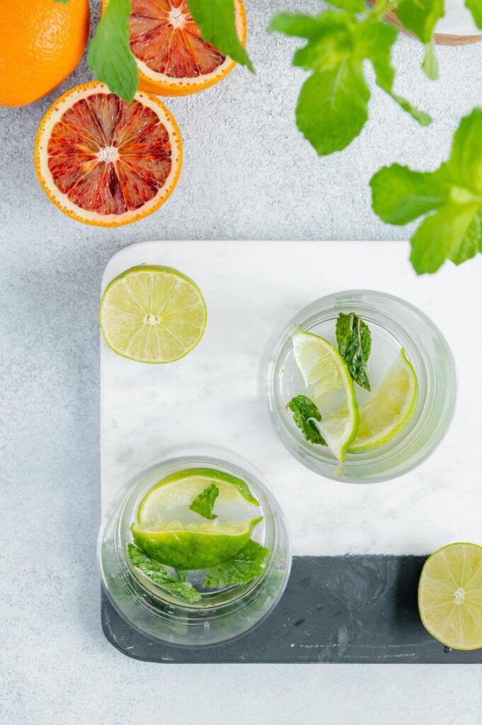 Step one - muddle the mint and lime in the glass.