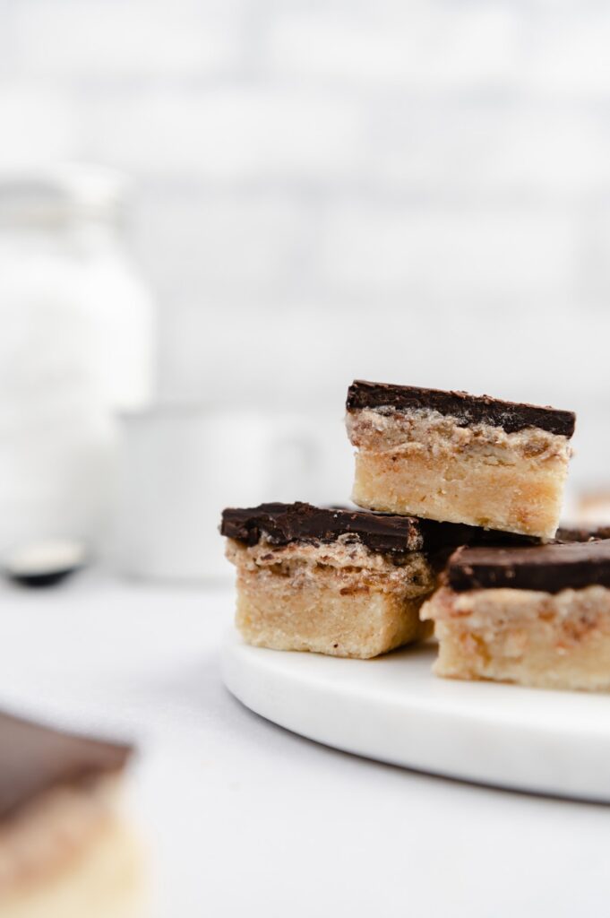 Millionaire shortbread bars on Woodville Workshop backdrop.