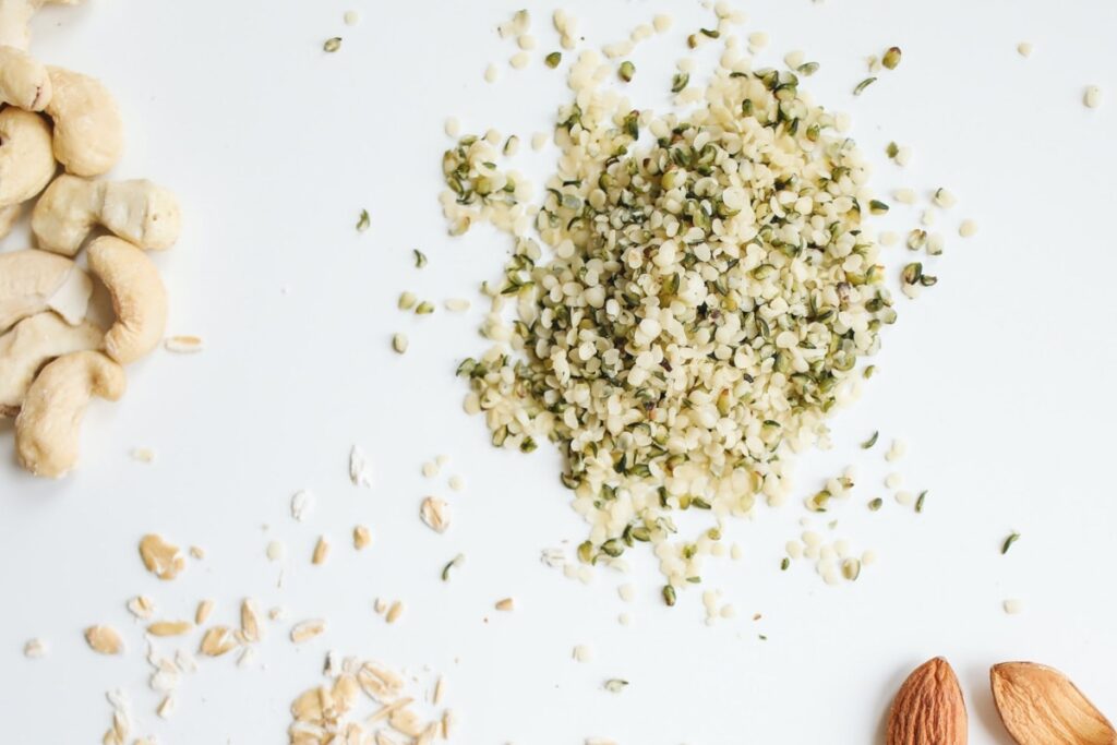 Upclose of a pile of hemp seeds on a plain white backdrop.