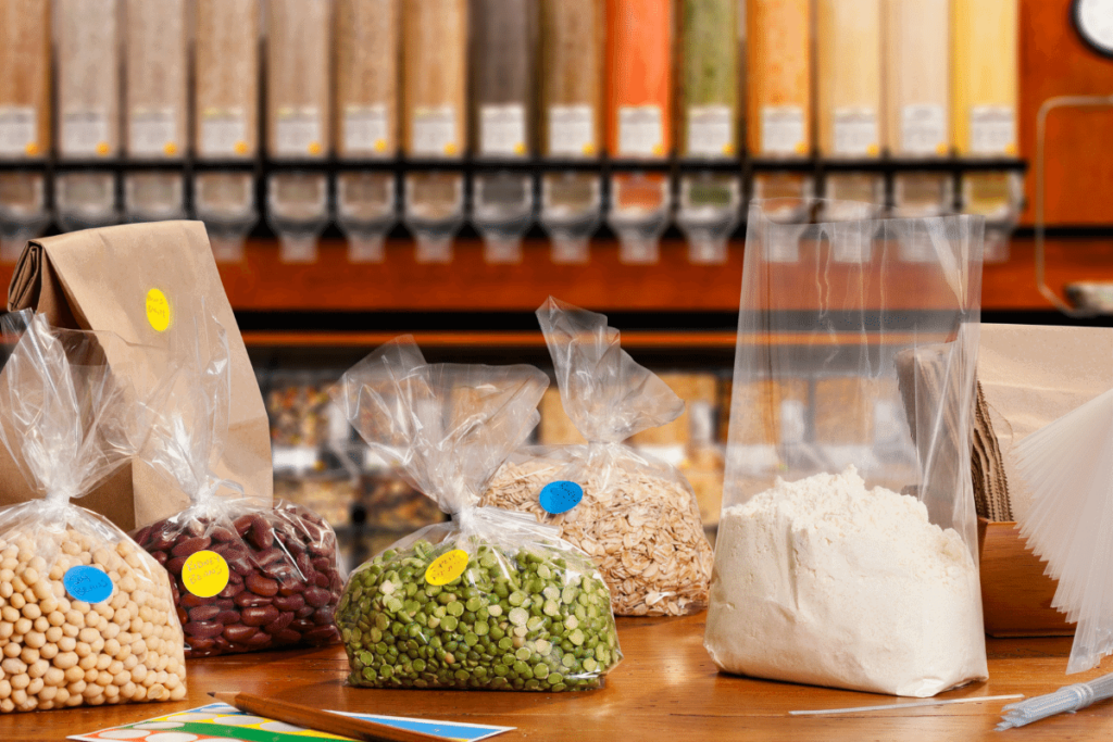 Different bulk items in bags like flour, oats, beans, and peas.