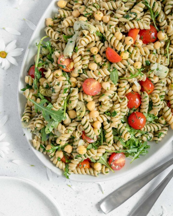 Overhead of a serving platter with vegan pesto pasta salad.