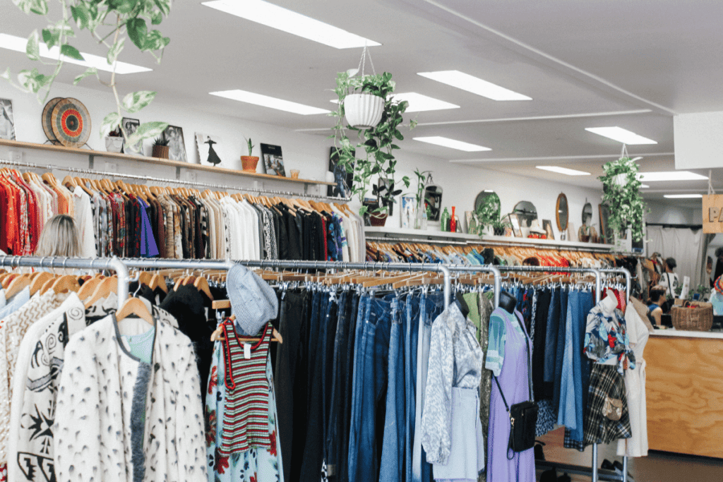 A thrift store with racks of clothing.