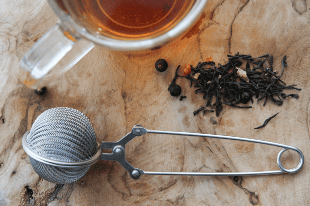 Loose leaf tea next to a strainer.
