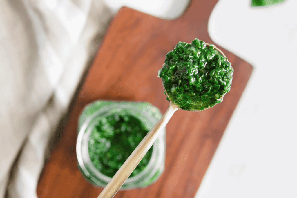 Upclose of a spoonful of pesto sauce.