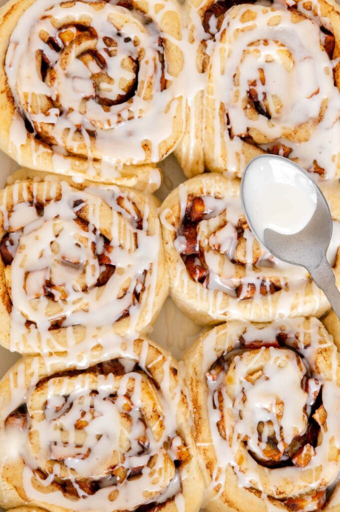 Upclose of homemade apple cinnamon rolls with icing.