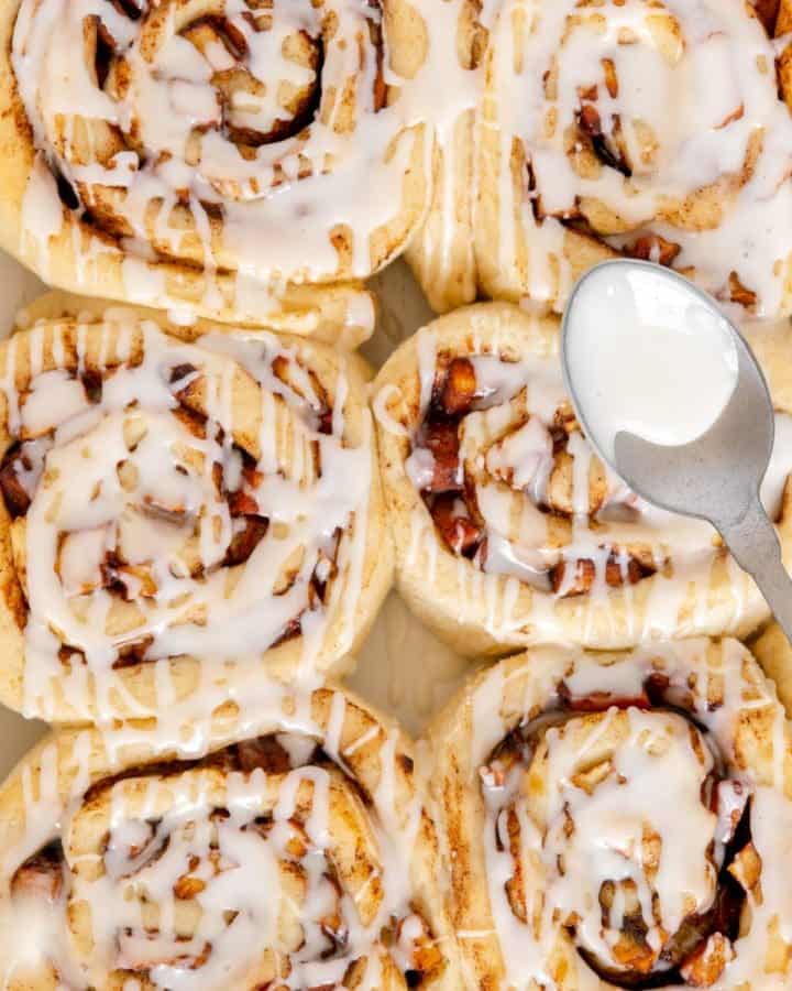 Upclose of homemade apple cinnamon rolls with icing.