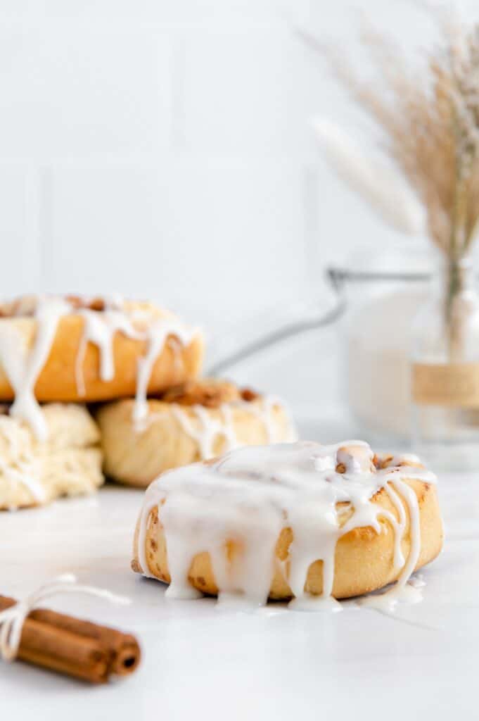 A breakfast cinnamon roll dripping with homemade icing.