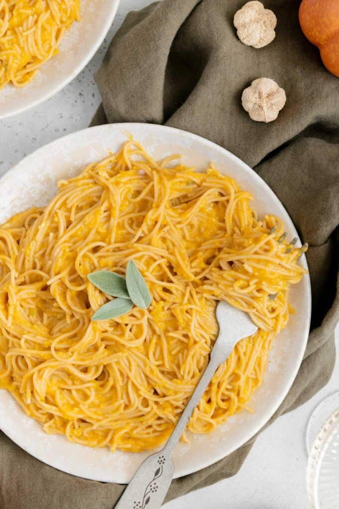 Pumpkin pasta twirled around a fork.