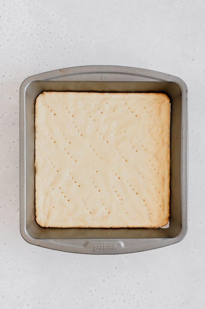 The cooked vegan shortbread crust in a baking pan.