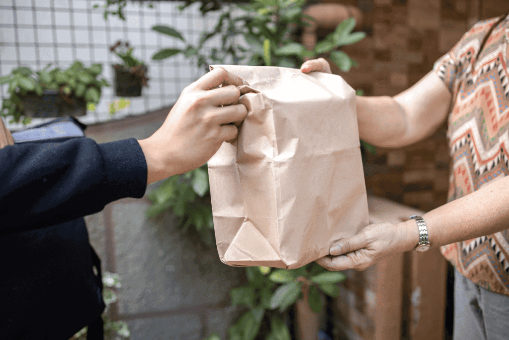 A delivery of food being handed over.