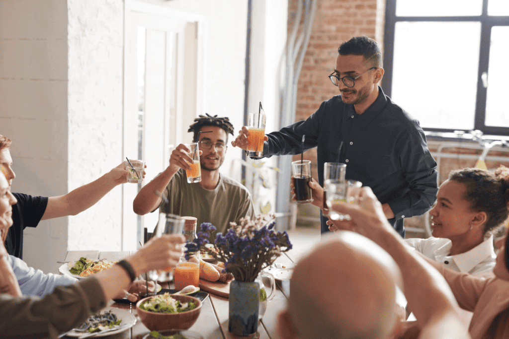 People around a table making a toast.