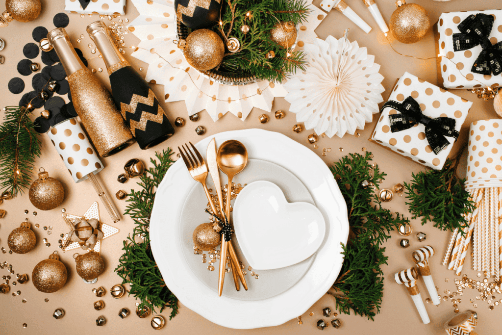 A gold, black and white Christmas dinner place setting.