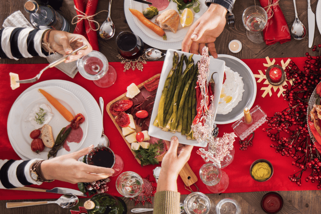 A side dish of asparagus being passed across the table.