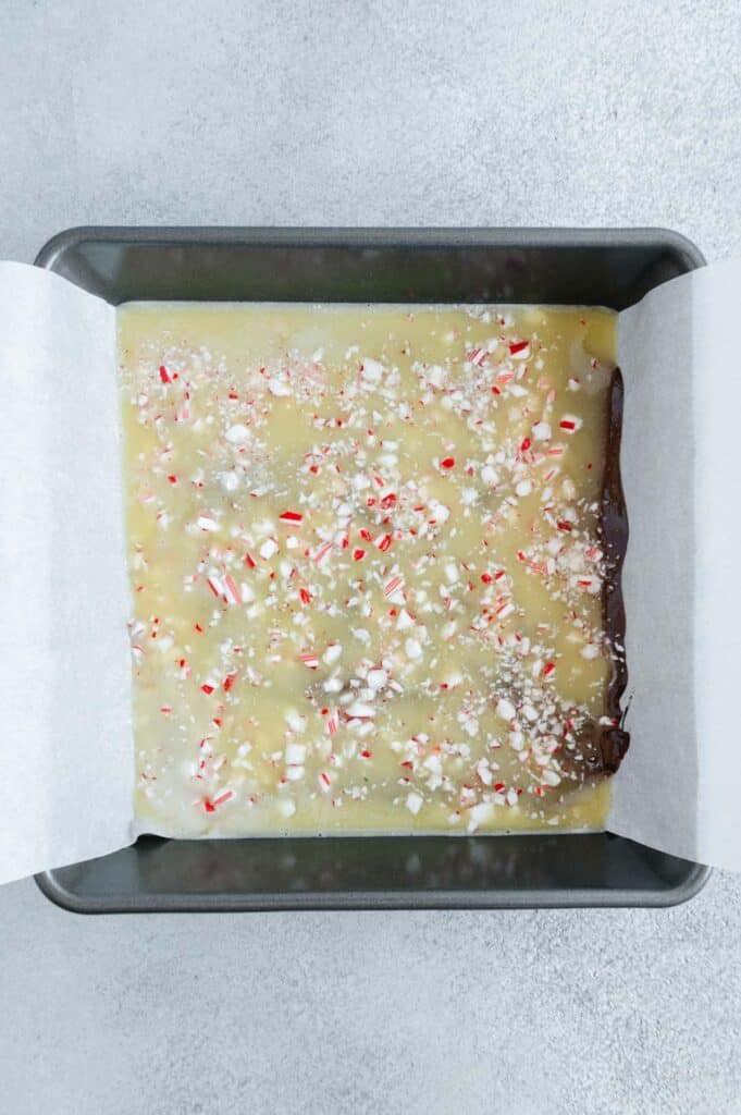 The crushed candy cane sprinkled over the white chocolate layer.