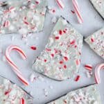 Peppermint bark scattered around with candy canes.