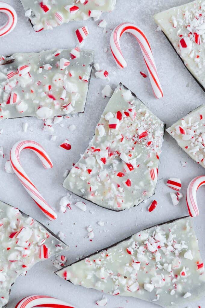 Peppermint bark scattered around with candy canes.