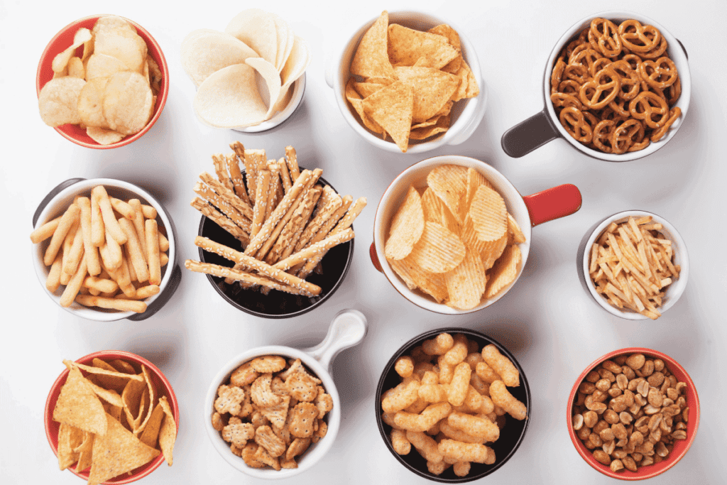 Different snack foods in small bowls.