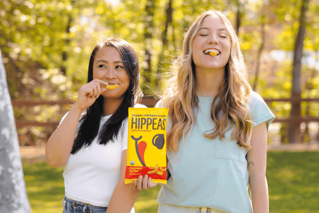 Two friends enjoying a bag of Hippeas together.