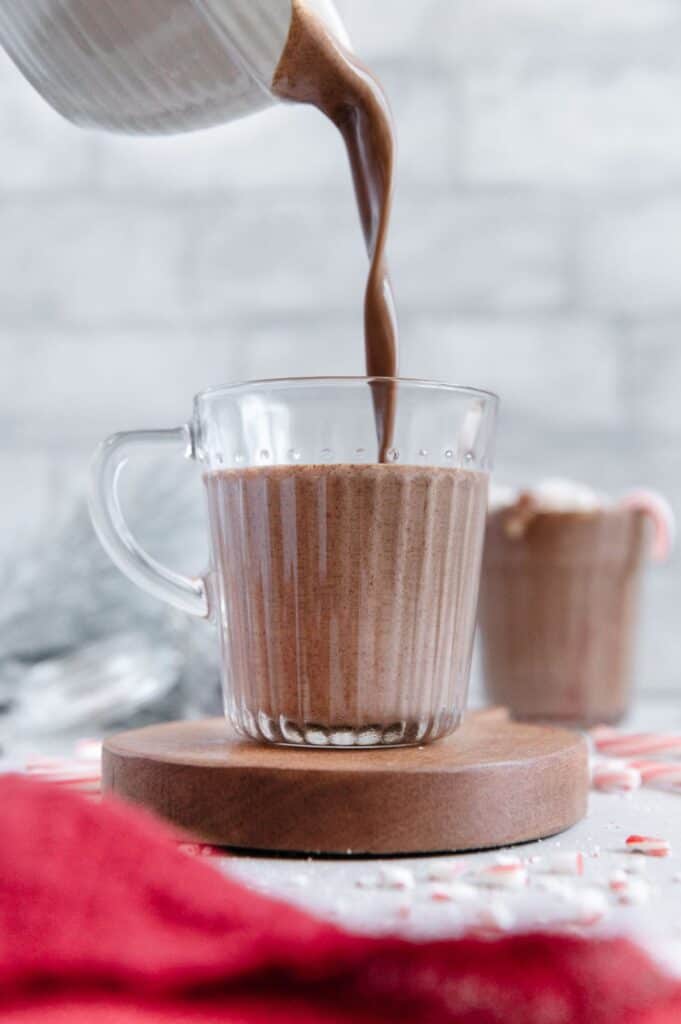 Vegan hot coco being poured in a mug.