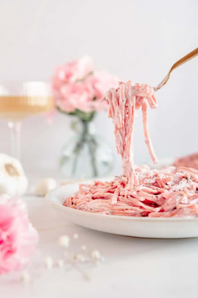 A fork full of vegan pink pasta.
