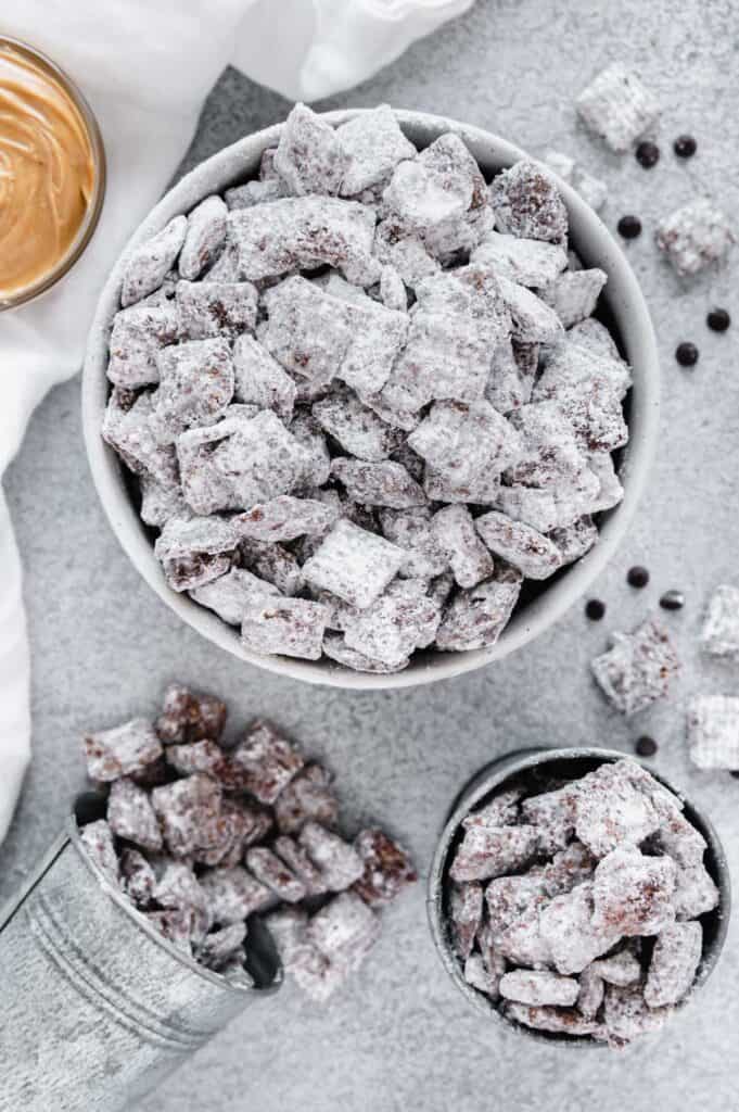 Puppy chow in a big bowl and individual serving cups.