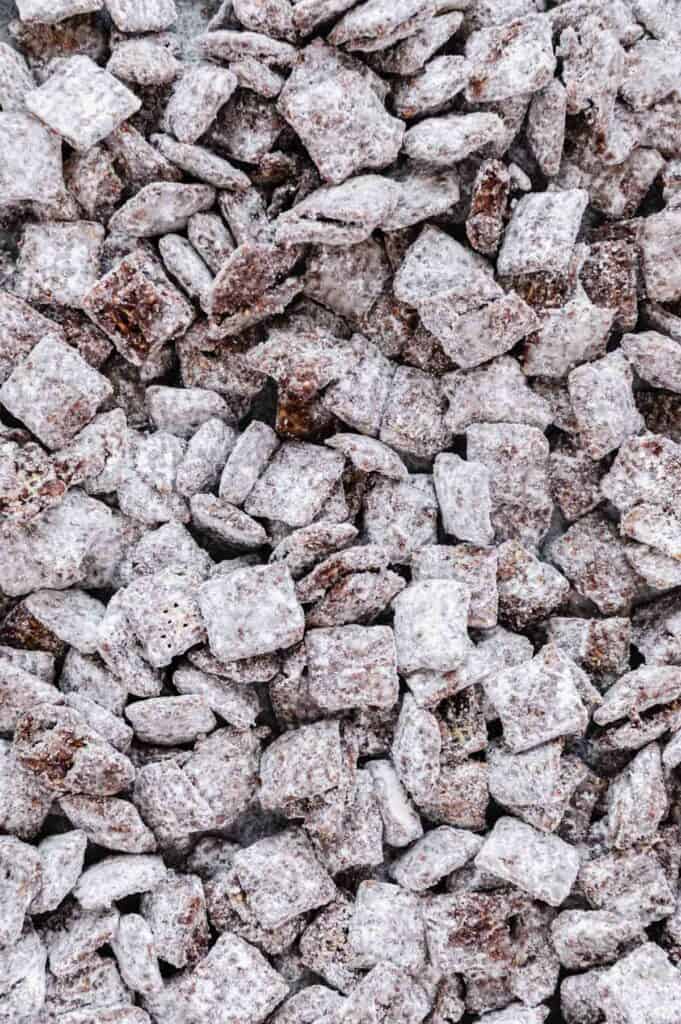 Upclose of the texture, chocolate, and powdered sugar of the puppy chow.
