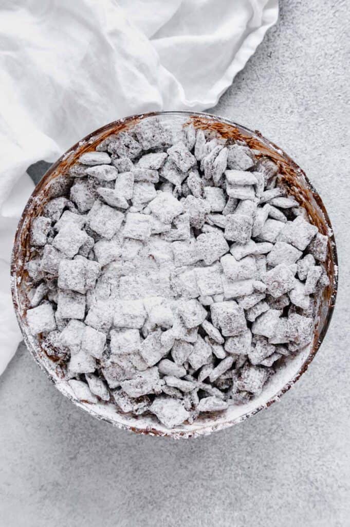 Powdered sugar tossed with the chocolate and peanut butter coated Chex cereal.
