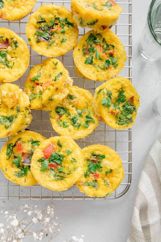 A bunch of egg bites on a cooling rack.