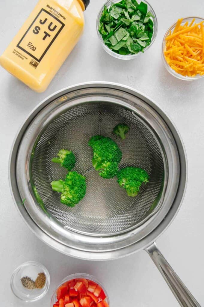 Steamed broccoli in a pot with water.