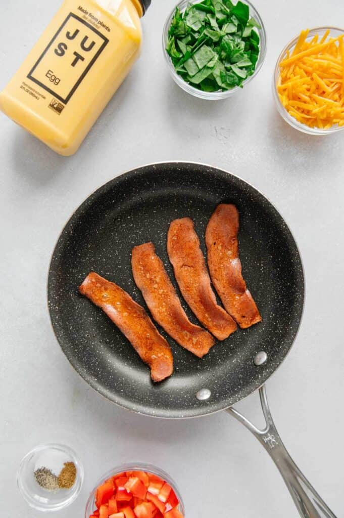 Cooked Lightlife bacon in a skillet.