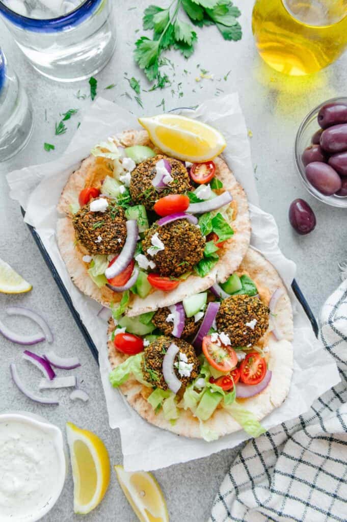 Two falafel sandwiches in a serving tray.