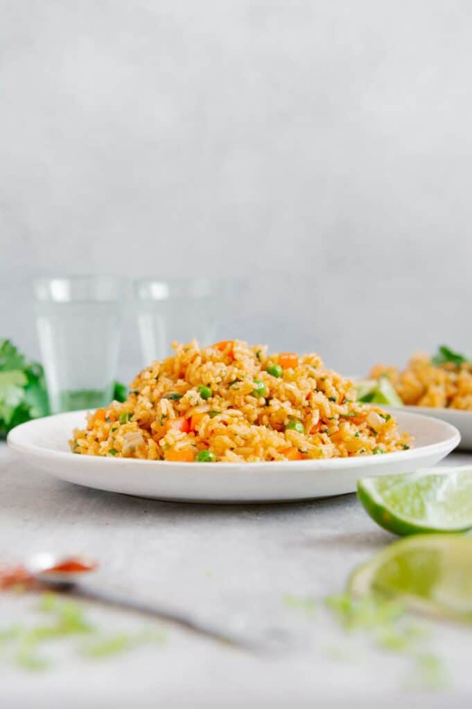 Mexican rice with peas and carrots on a plate.