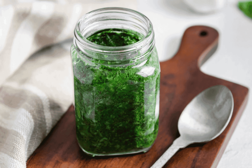 A jar full of vegan pesto sauce.