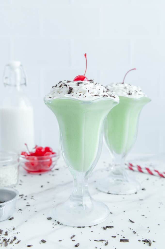 A healthy Shamrock shake topped with whipped cream and a cherry.