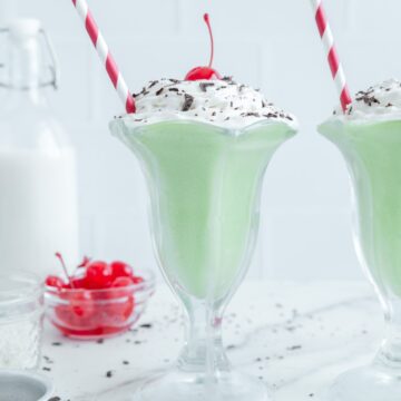 A Shamrock shake with a red and white straw.