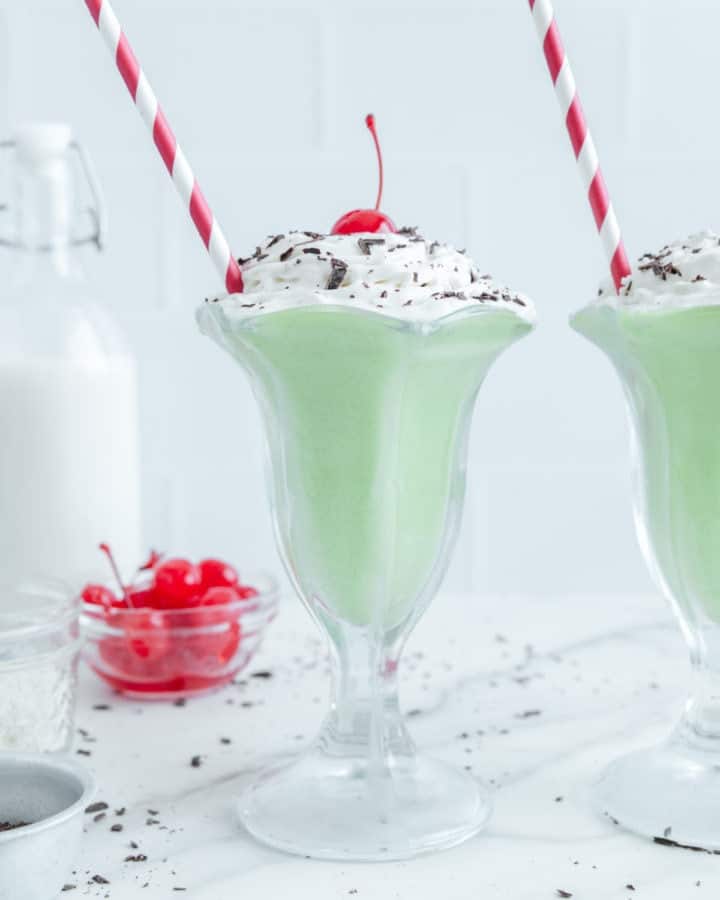 A Shamrock shake with a red and white straw.