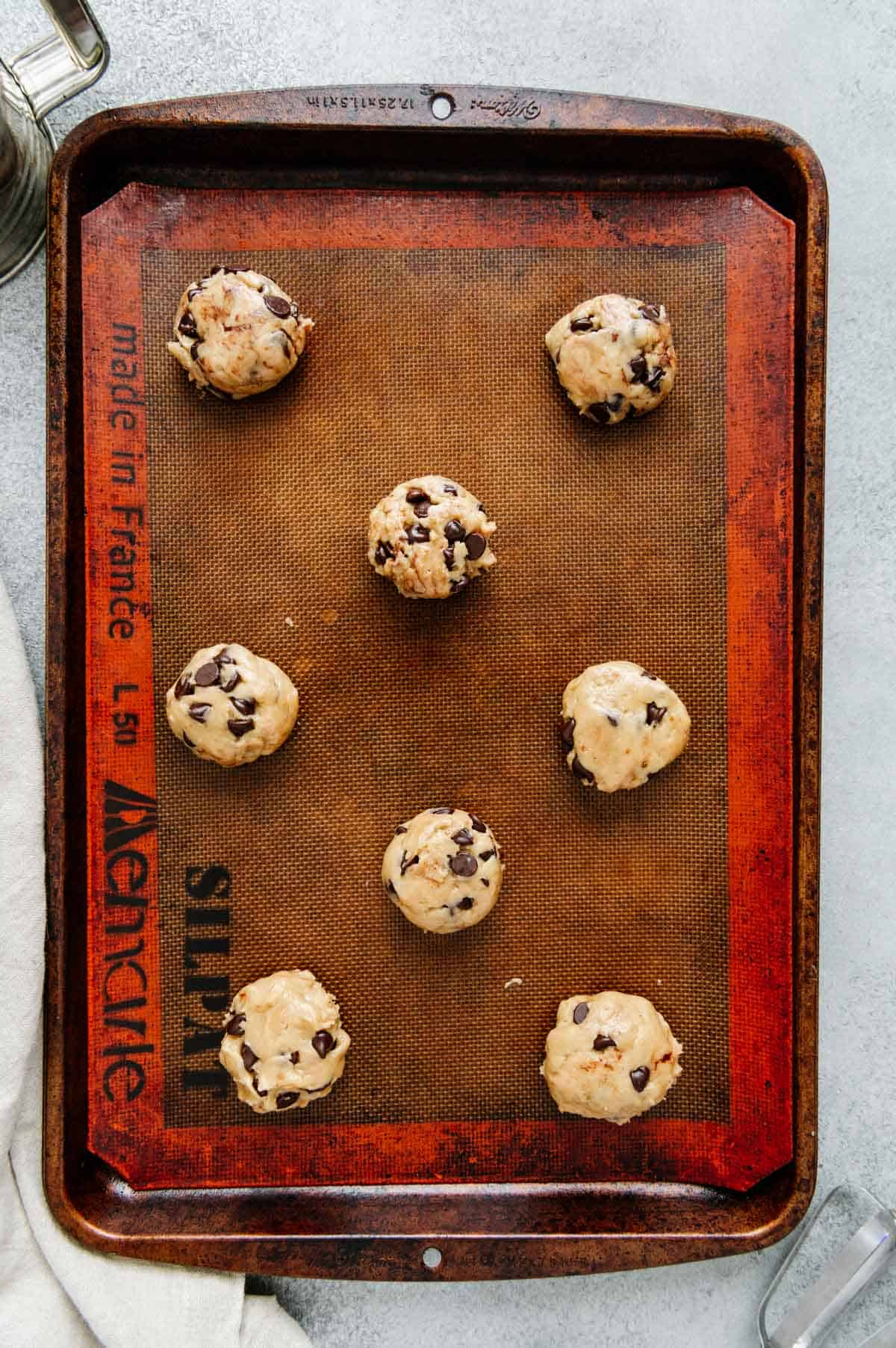 Nutella stuffed cookies on a baking sheet.