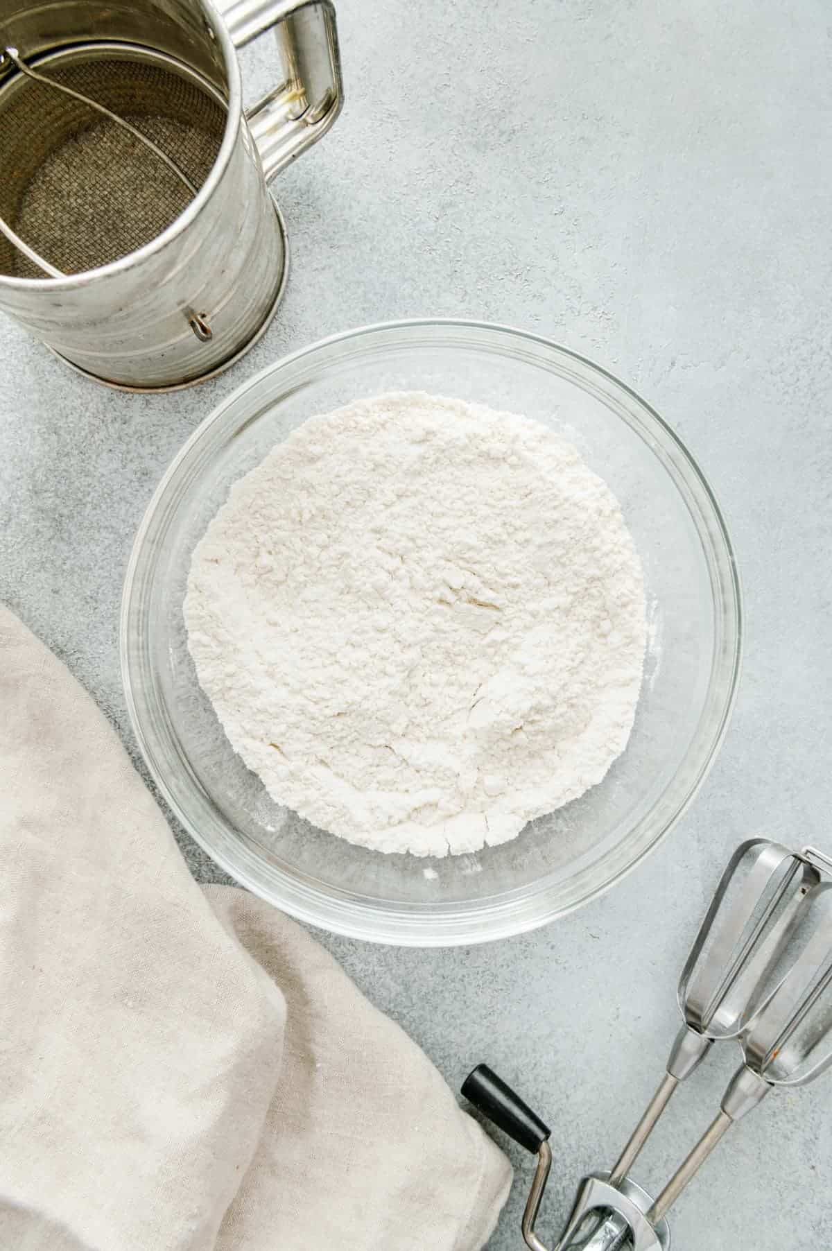 Flour, baking soda, baking powder, and salt in a mixing bowl.