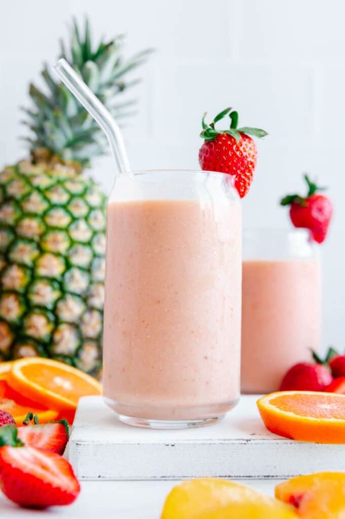 A dairy-free tropical smoothie with a glass straw.